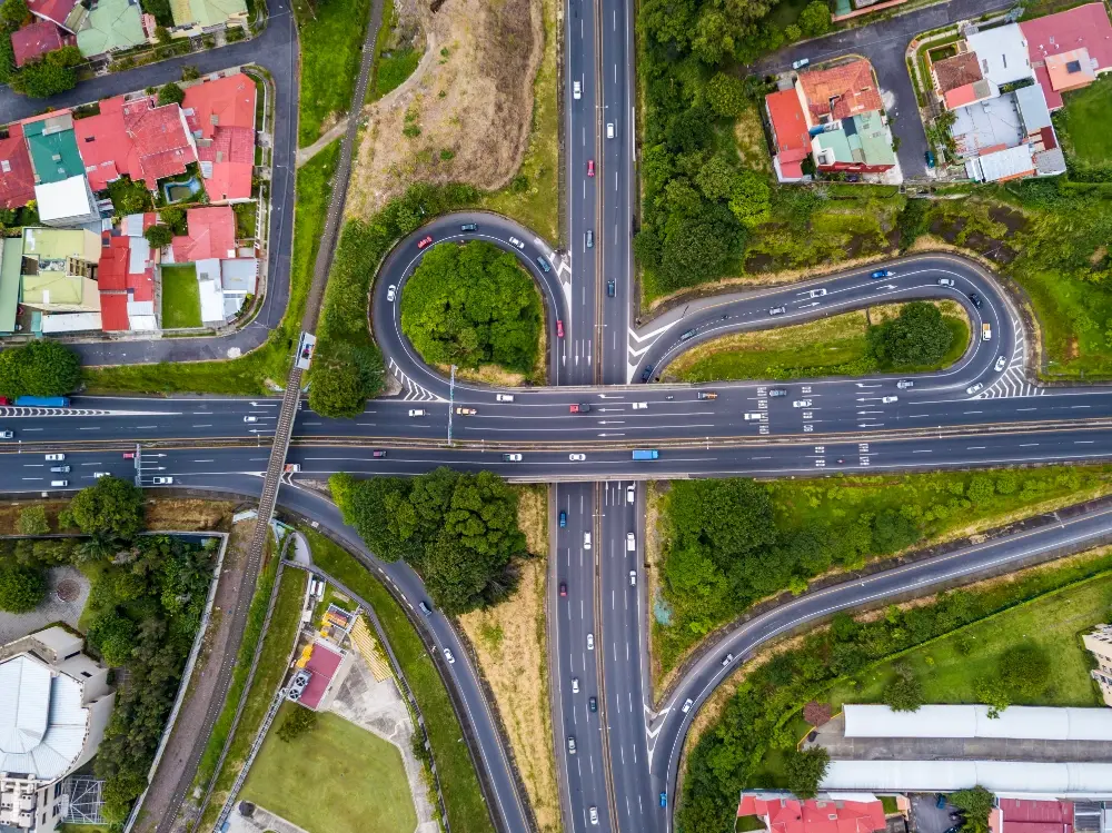 Aerial view of a roadway interchange and surrounding parcels illustrating site layout and land development planning 