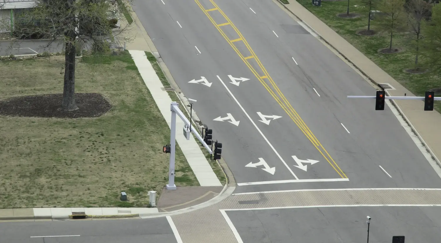 Aerial view of a signalized intersection with turn lane markings illustrating roadway and street design