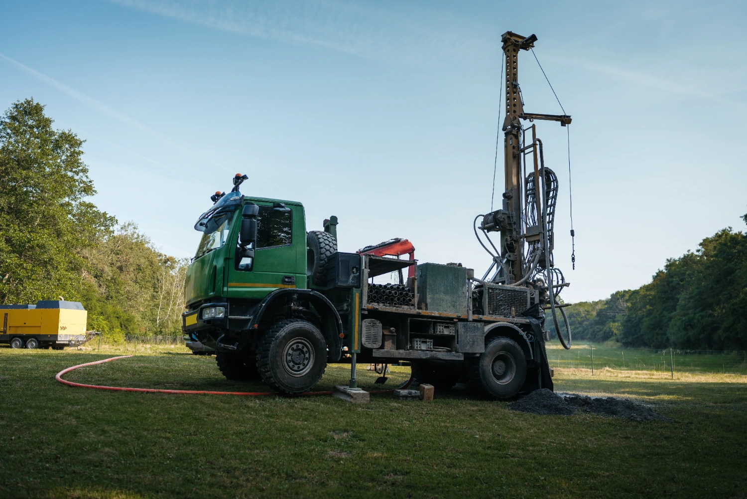 Water well drilling rig actively drilling a borehole for groundwater availability testing