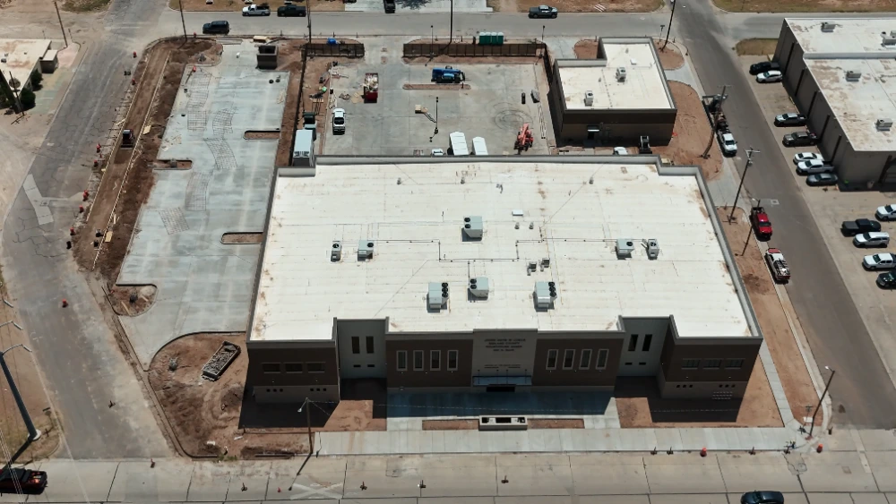 Midland County Justice of the Peace Annex: Front elevation showing the masonry facade and entry, with sidewalks and curbing in progress along Main Street.