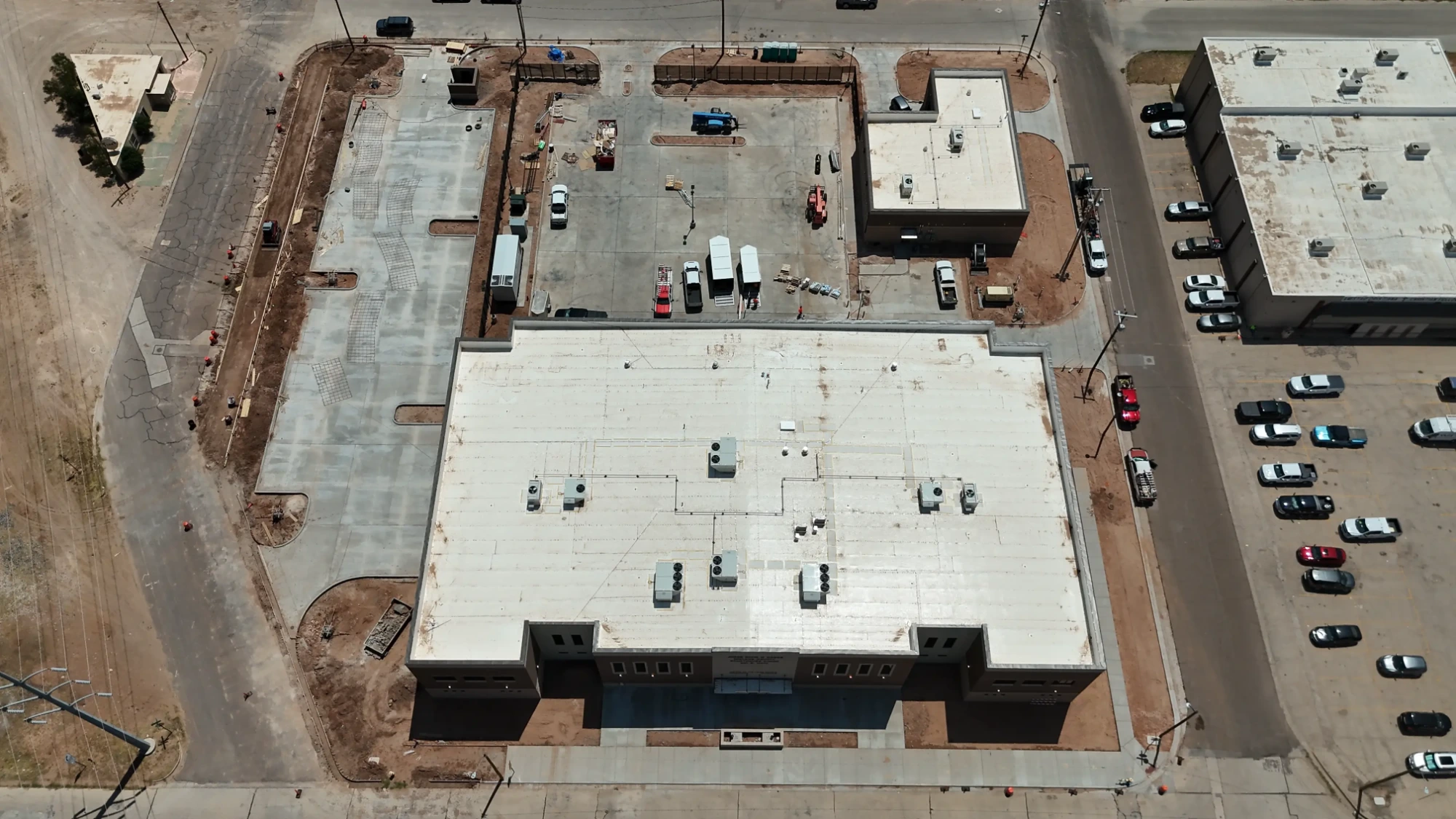 Midland County Justice of the Peace Annex: Front elevation showing the masonry facade and entry, with sidewalks and curbing in progress along Main Street.
