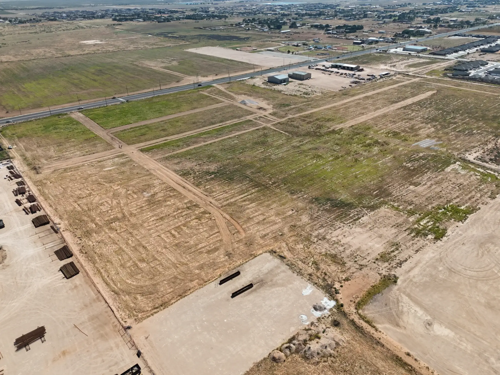 The Nest Subdivision: The tract before construction, with lot corridors mowed in and the road alignment visible across the site.
